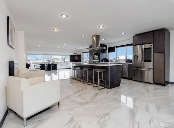 a large kitchen with stainless steel appliances lots of counter space and windows