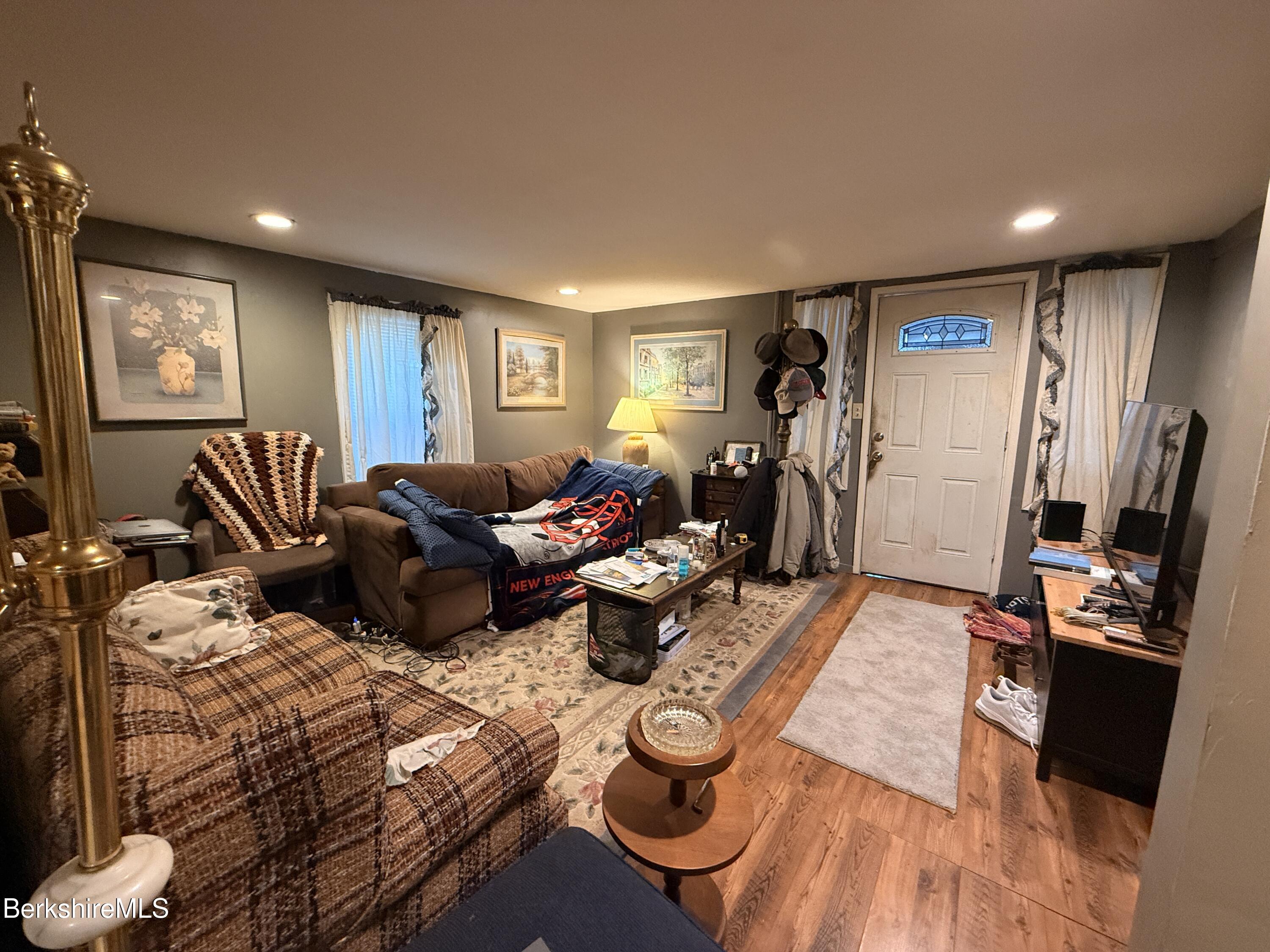 422 West Main Street North Adams, MA 01247 - Photo 6 of 24 a living room with furniture a window and gym equipment