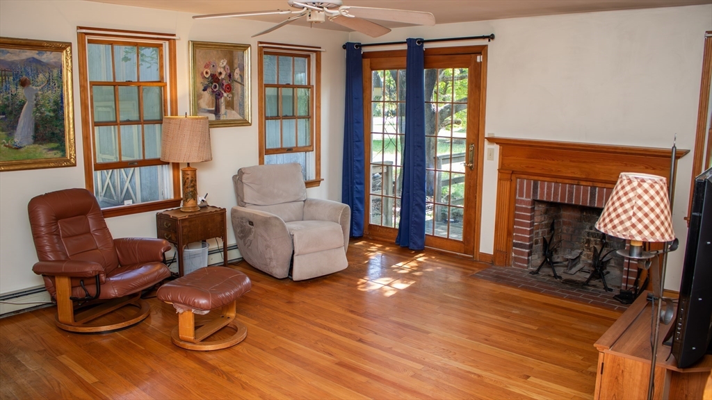 562 North Avenue Rochester, MA 02770 - Photo 12 of 32 a living room with furniture a window and a fireplace