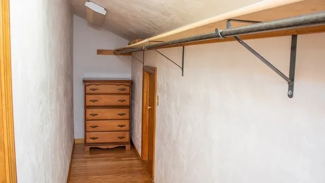 a view of walk in closet with clothes