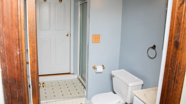 a white toilet sitting next to a shower curtain