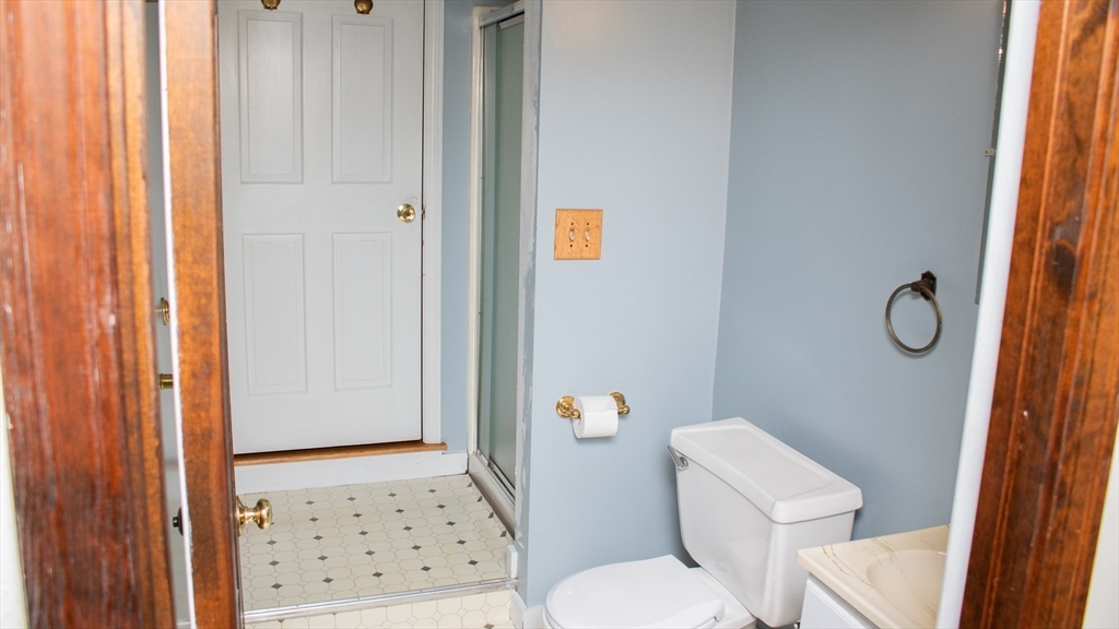 562 North Avenue Rochester, MA 02770 - Photo 22 of 32 a white toilet sitting next to a shower curtain