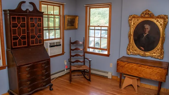 a view of a workspace with furniture and a window