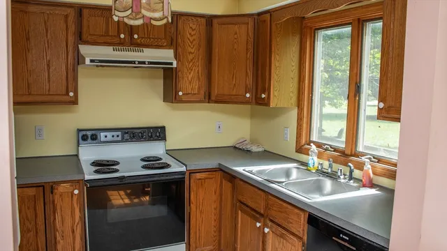 a kitchen with a sink stove and cabinets