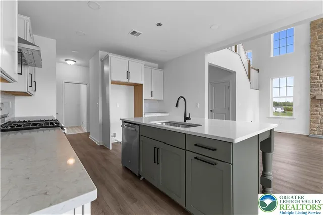 a kitchen with sink refrigerator and stove