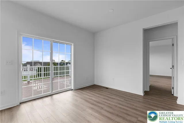 a view of wooden floor and windows in a room