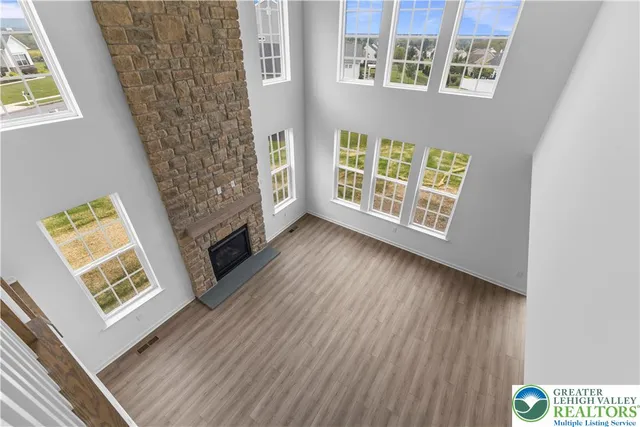 a view of front door with wooden floor and windows