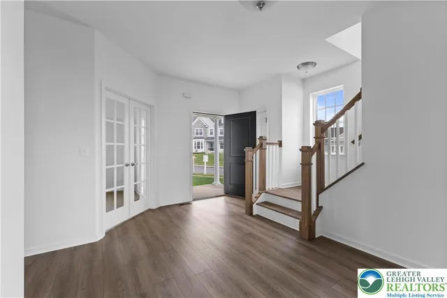 a view of an entryway with wooden floor and stairs