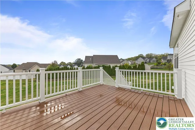 a view of balcony with wooden floor and fence