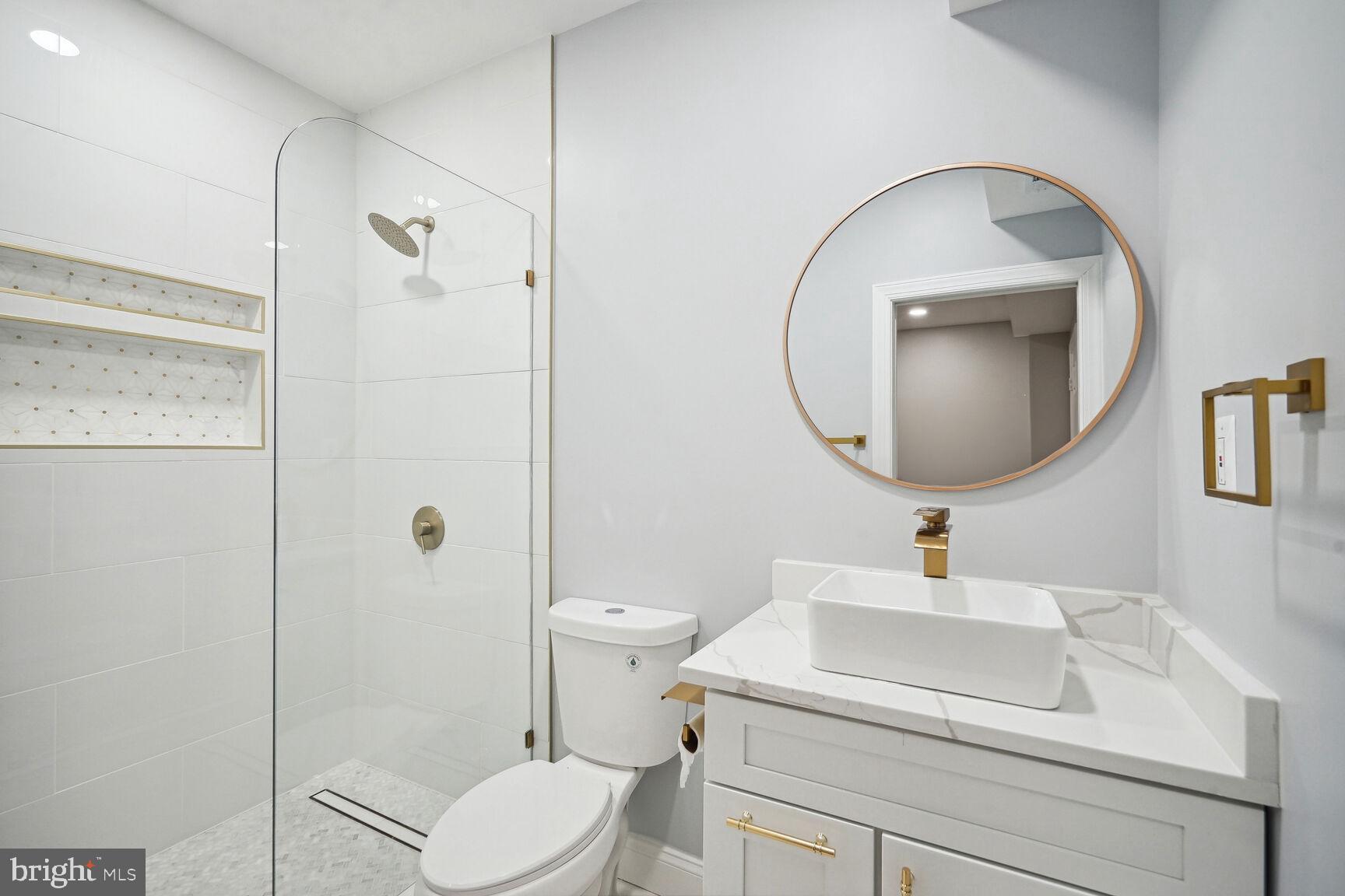 6390 Gayfields Road Alexandria, VA 22315 - Photo 11 of 15 a bathroom with a toilet sink vanity granite and a mirror