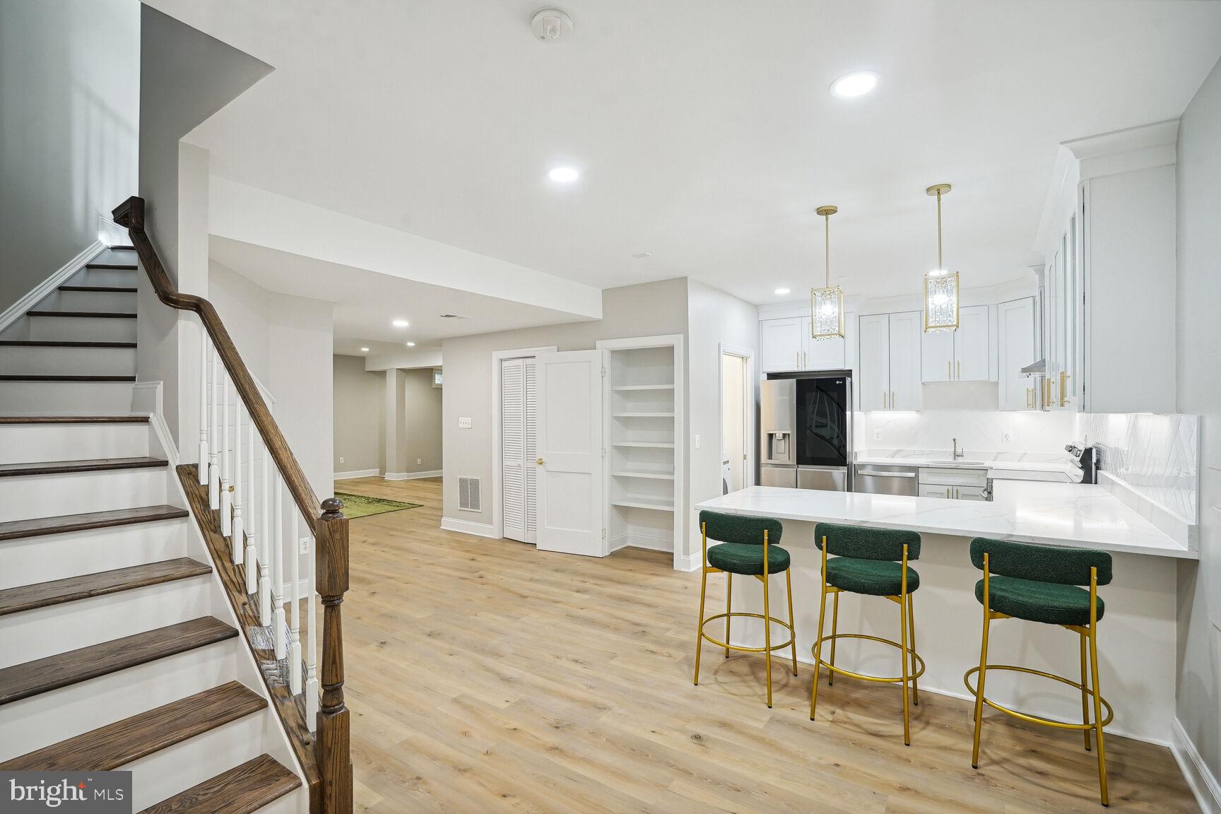 6390 Gayfields Road Alexandria, VA 22315 - Photo 2 of 15 a room with stainless steel appliances kitchen island granite countertop furniture and a wooden floor