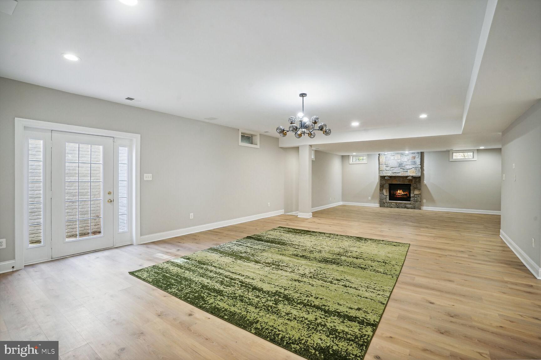 6390 Gayfields Road Alexandria, VA 22315 - Photo 4 of 15 a view of a livingroom with a fireplace wooden floor and chandelier