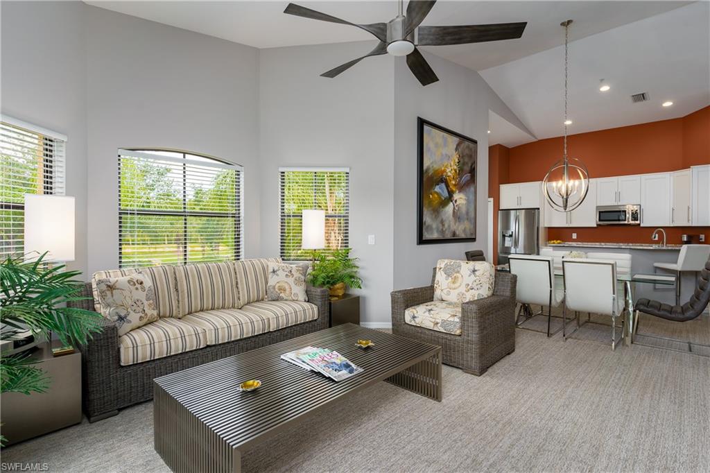 195 Vintage Circle, Unit E205 Naples, FL 34119 - Photo 11 of 34 a living room with furniture and a large window