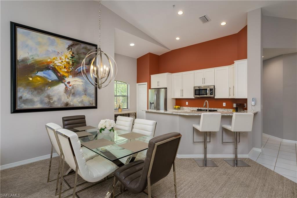195 Vintage Circle, Unit E205 Naples, FL 34119 - Photo 13 of 34 a view of a dining room with furniture