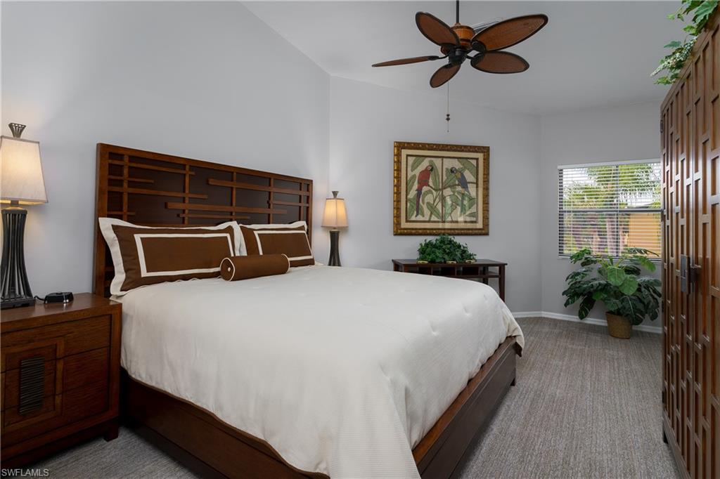 195 Vintage Circle, Unit E205 Naples, FL 34119 - Photo 17 of 34 a bedroom with a bed and a potted plant