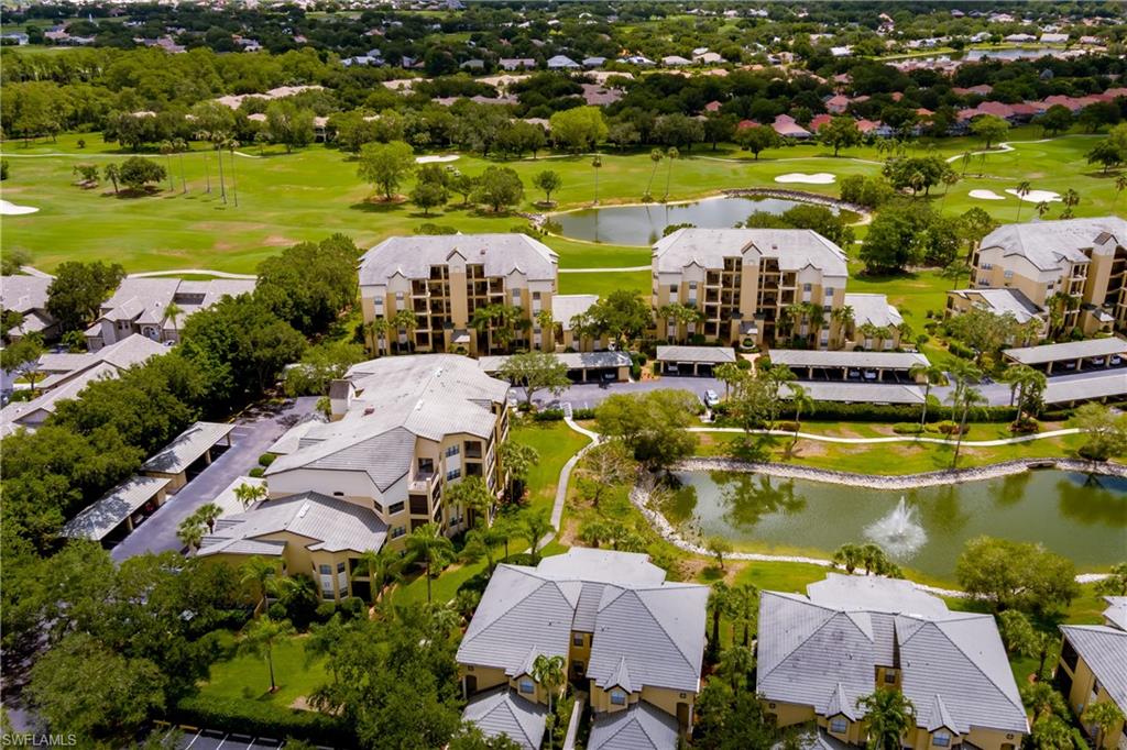 195 Vintage Circle, Unit E205 Naples, FL 34119 - Photo 30 of 34 an aerial view of residential houses with outdoor space