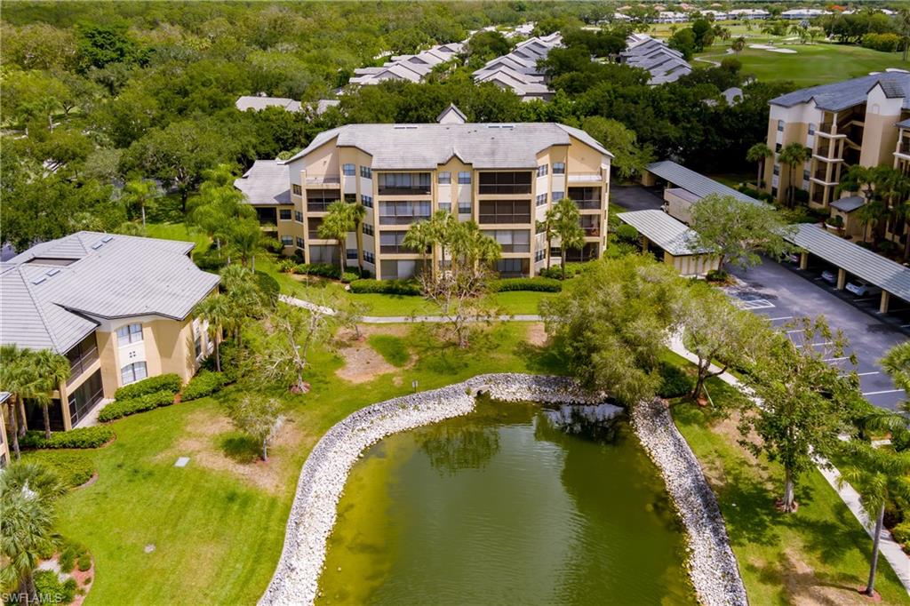 195 Vintage Circle, Unit E205 Naples, FL 34119 - Photo 34 of 34 a view of a house with pool and chairs