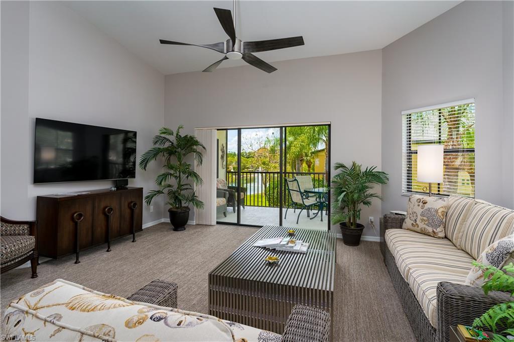 195 Vintage Circle, Unit E205 Naples, FL 34119 - Photo 8 of 34 a living room with furniture and a flat screen tv