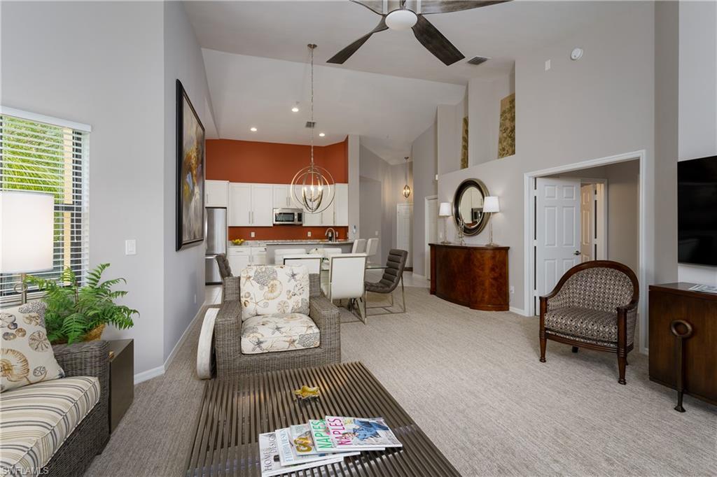 195 Vintage Circle, Unit E205 Naples, FL 34119 - Photo 10 of 34 a living room with furniture and wooden floor