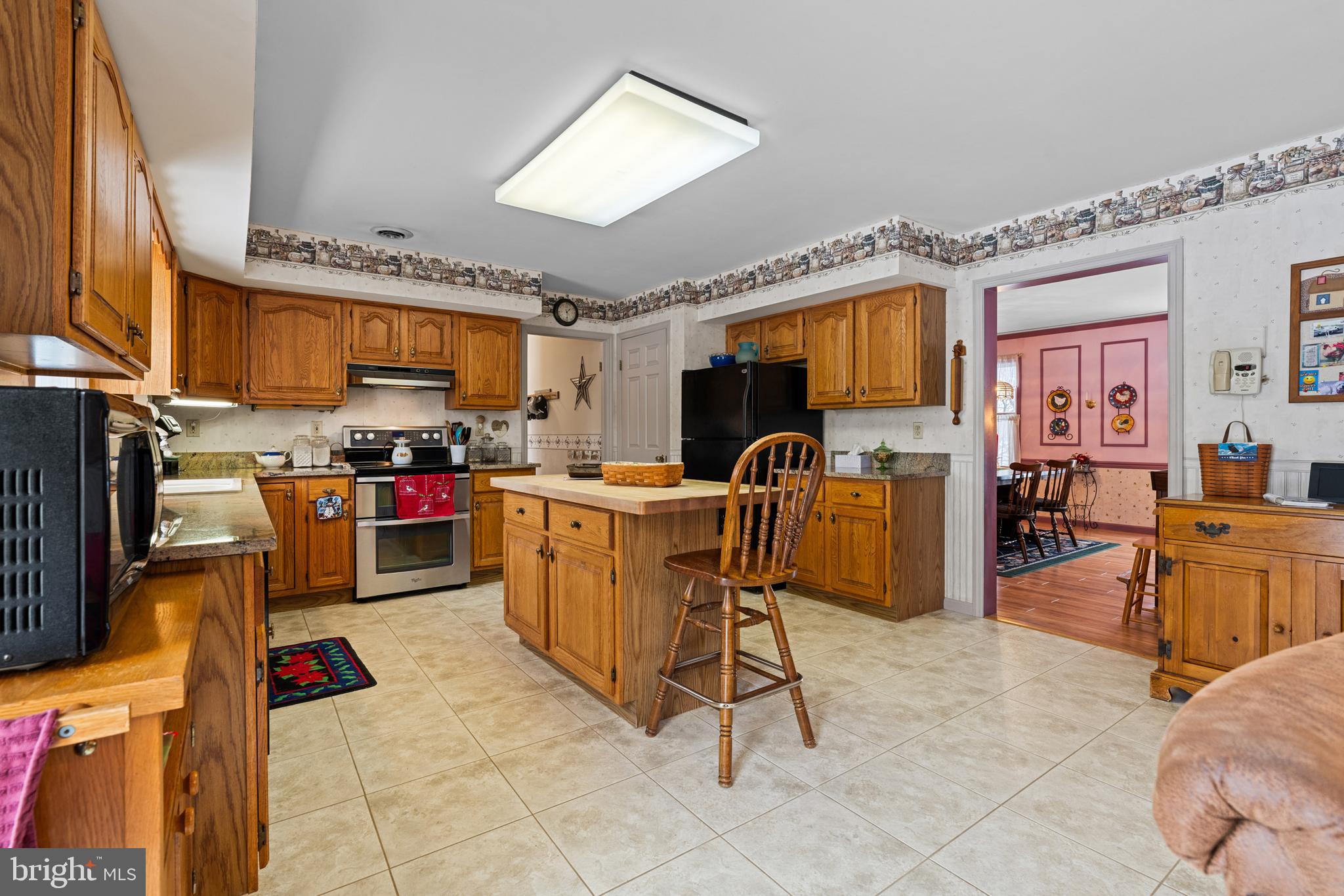 118 Middle Creek Road Gilbertsville, PA 19525 - Photo 23 of 108 a open kitchen with stainless steel appliances kitchen island granite countertop a refrigerator and a stove top oven