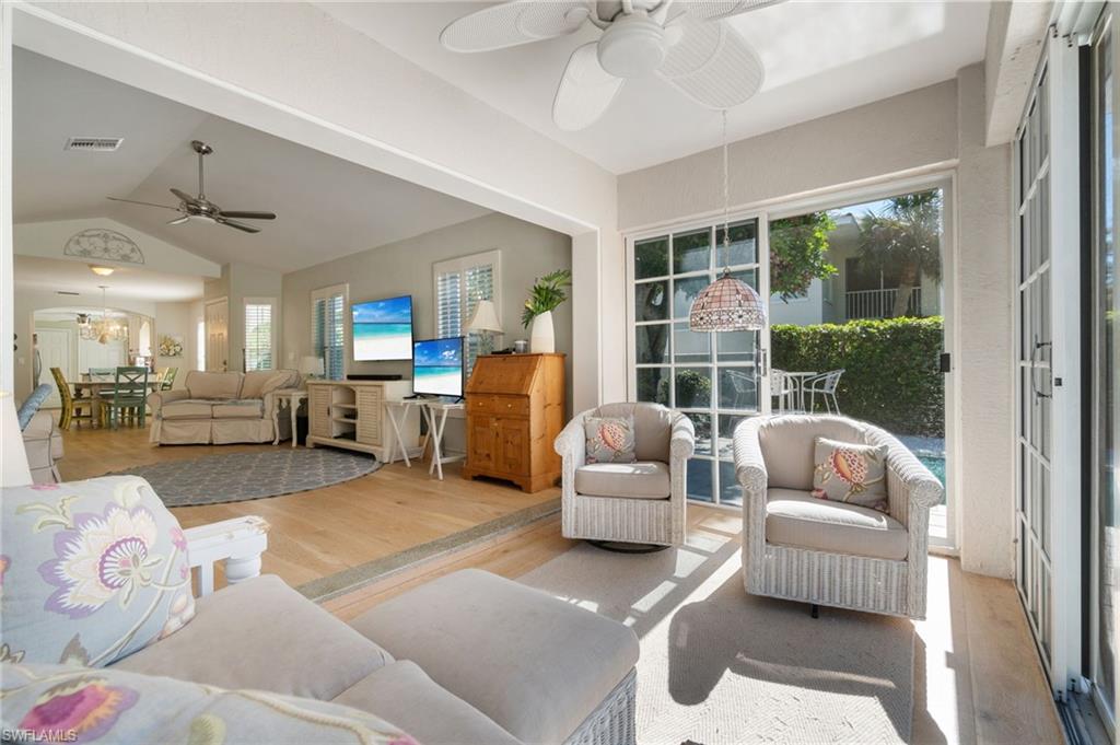 832 Rue Deville, Unit 5 Naples, FL 34108 - Photo 24 of 42 Sunroom featuring vaulted ceiling, ceiling fan, and a healthy amount of sunlight