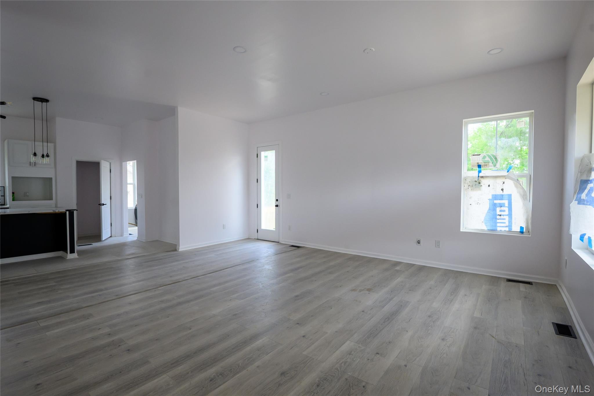 81 Silver Lake Sctn Road Middletown, NY 10940 - Photo 34 of 37 an empty room with wooden floor and windows