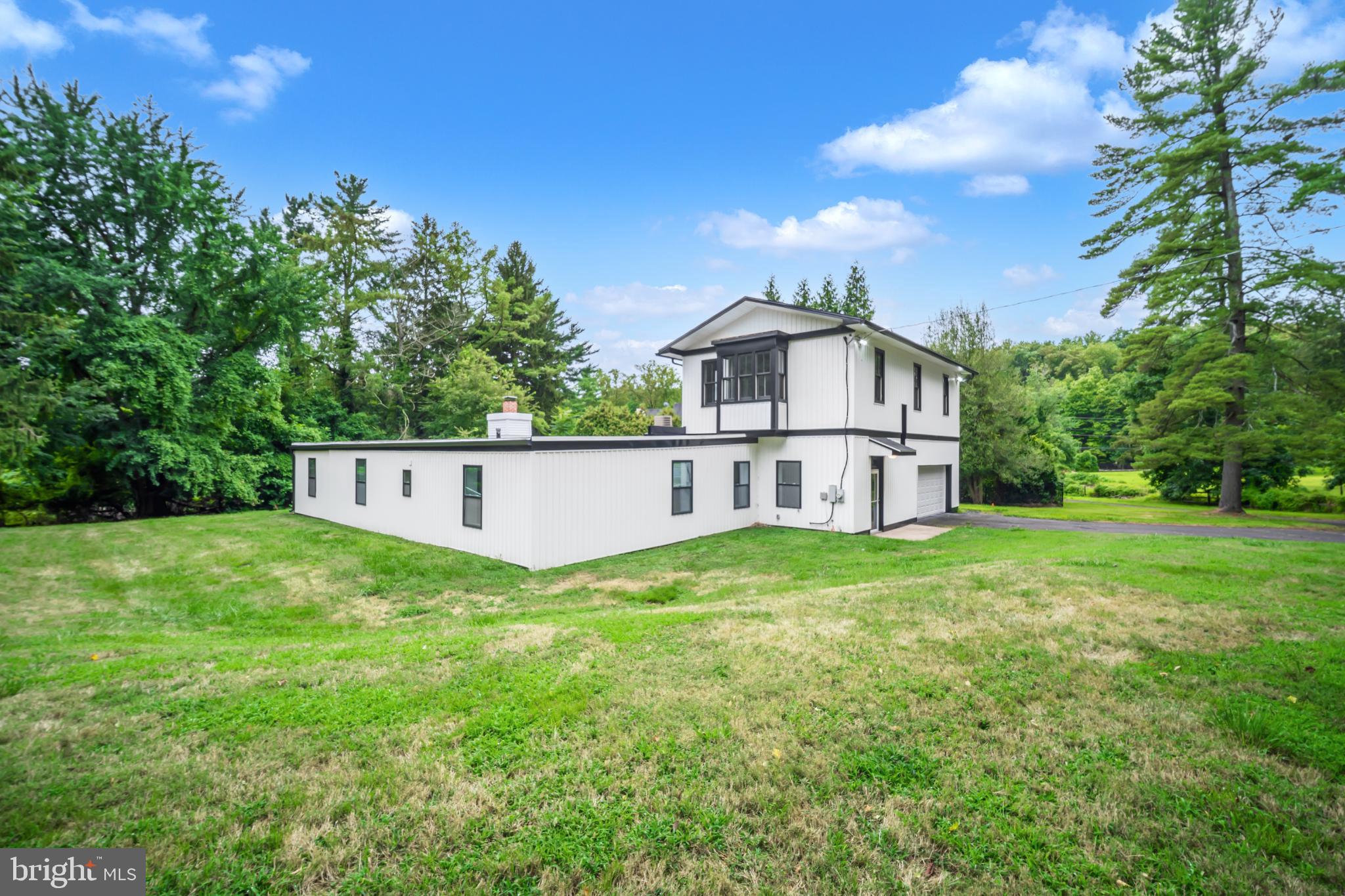 933 Fox Chase Road Jenkintown, PA 19046 - Photo 11 of 39 a white house with a small yard and big trees
