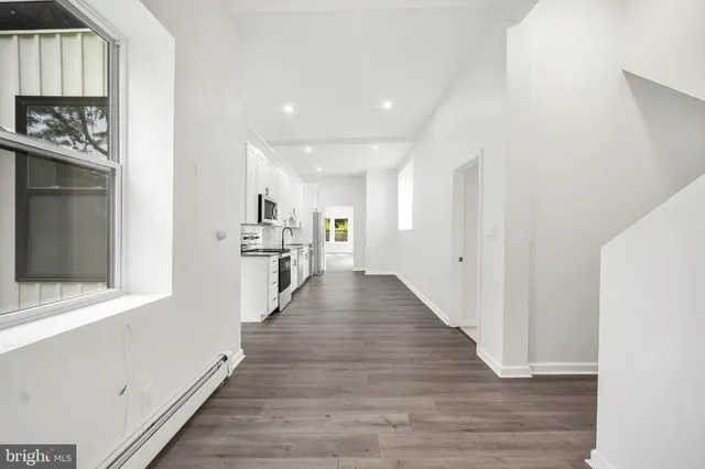 a view of a kitchen with wooden floor