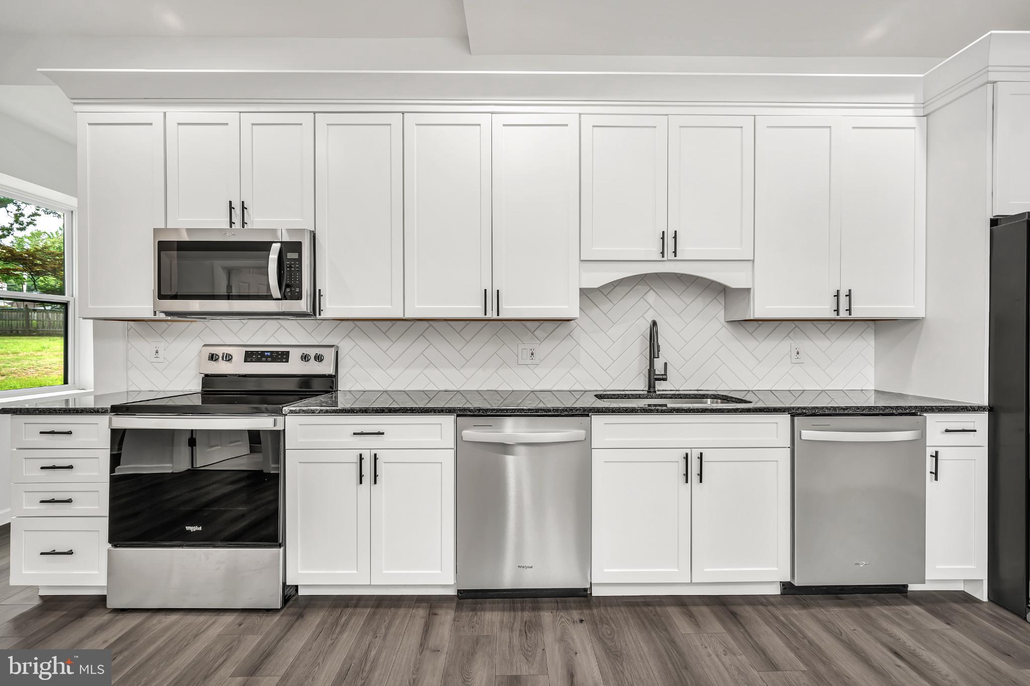 933 Fox Chase Road Jenkintown, PA 19046 - Photo 15 of 39 a kitchen with granite countertop white cabinets and stainless steel appliances
