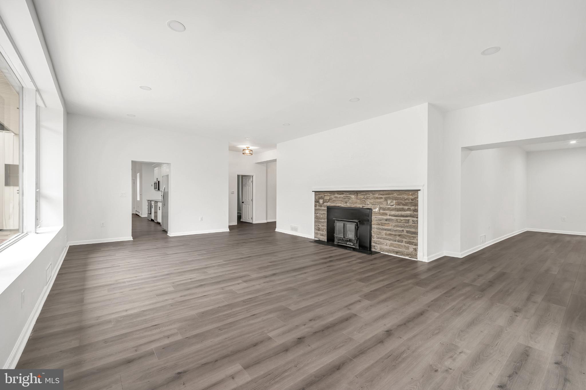 933 Fox Chase Road Jenkintown, PA 19046 - Photo 18 of 39 a view of an empty room with wooden floor fireplace and a window