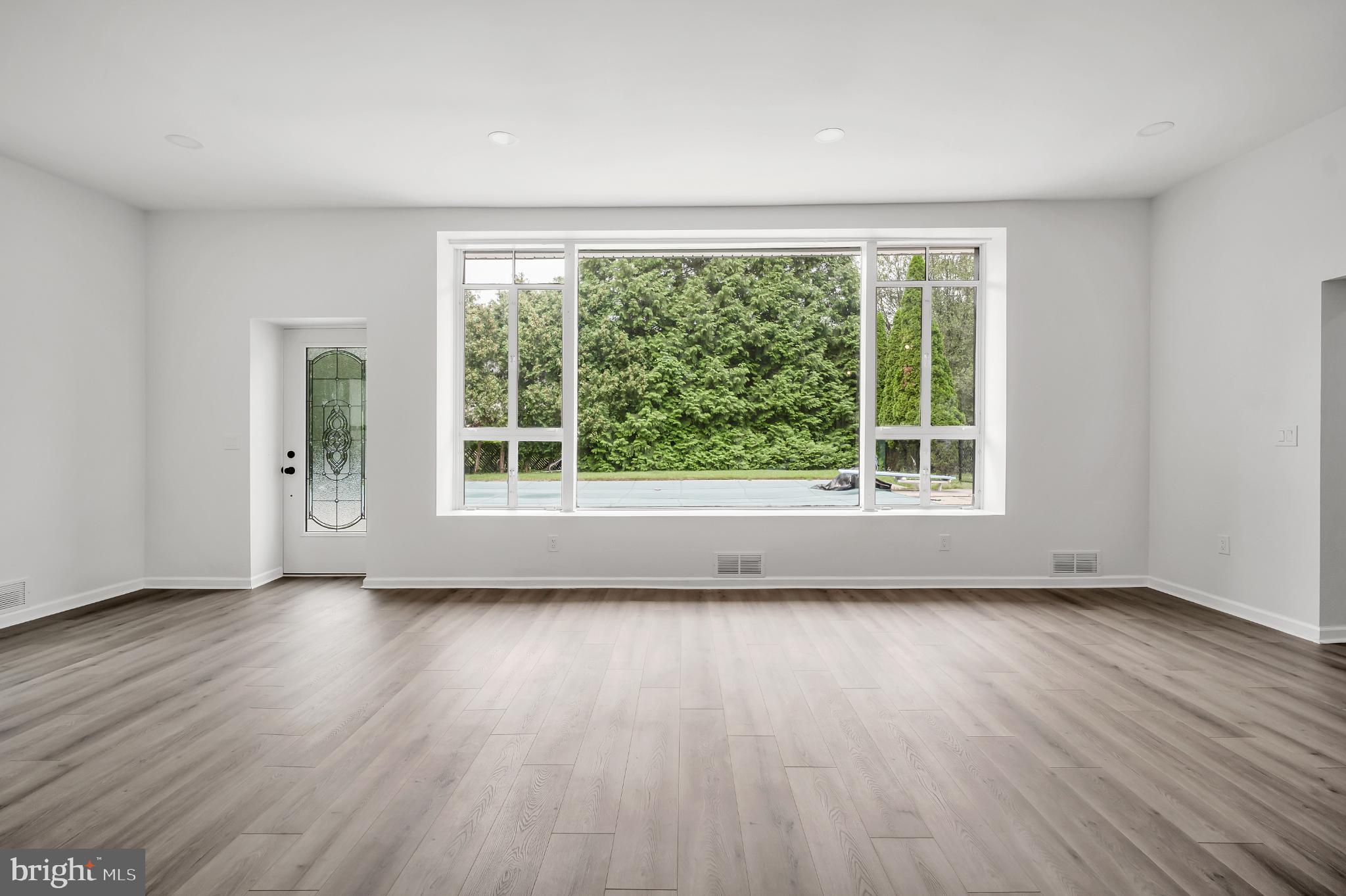 933 Fox Chase Road Jenkintown, PA 19046 - Photo 19 of 39 a view of an empty room with wooden floor and a window