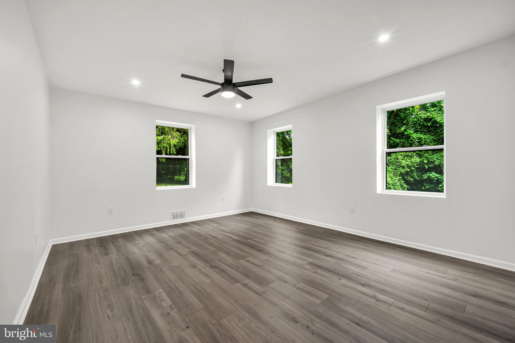 933 Fox Chase Road Jenkintown, PA 19046 - Photo 20 of 39 a view of an empty room with wooden floor and a window