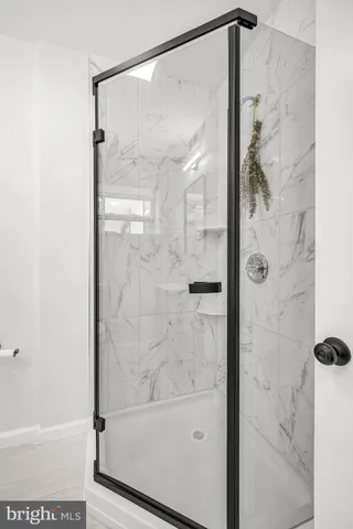 a bathroom with a glass shower door