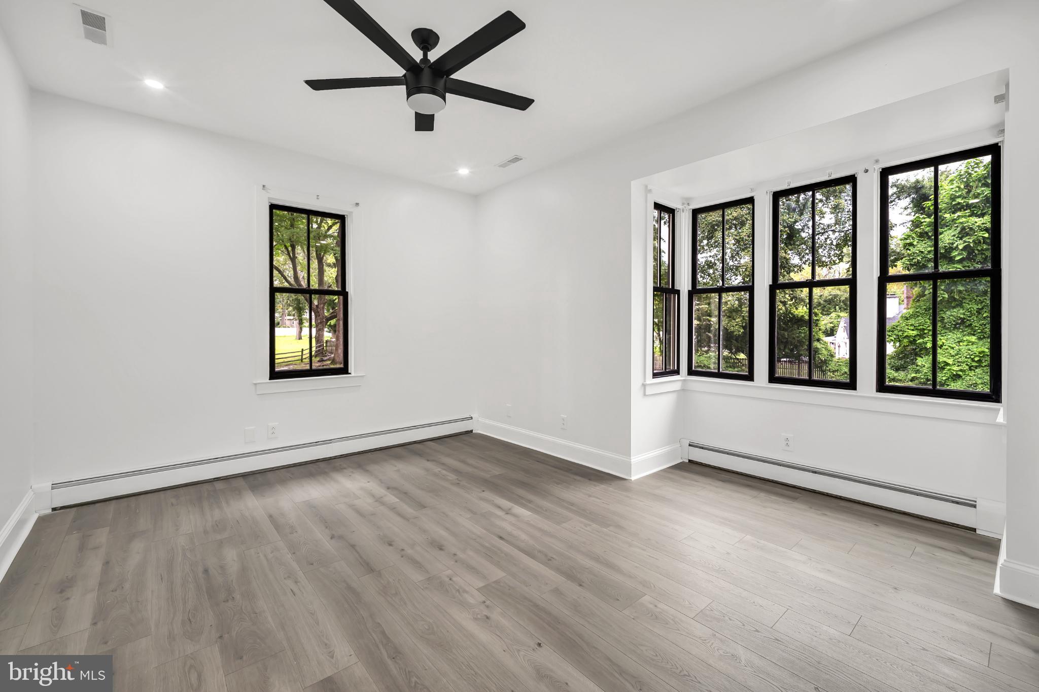 933 Fox Chase Road Jenkintown, PA 19046 - Photo 26 of 39 a view of an empty room with a window and wooden floor