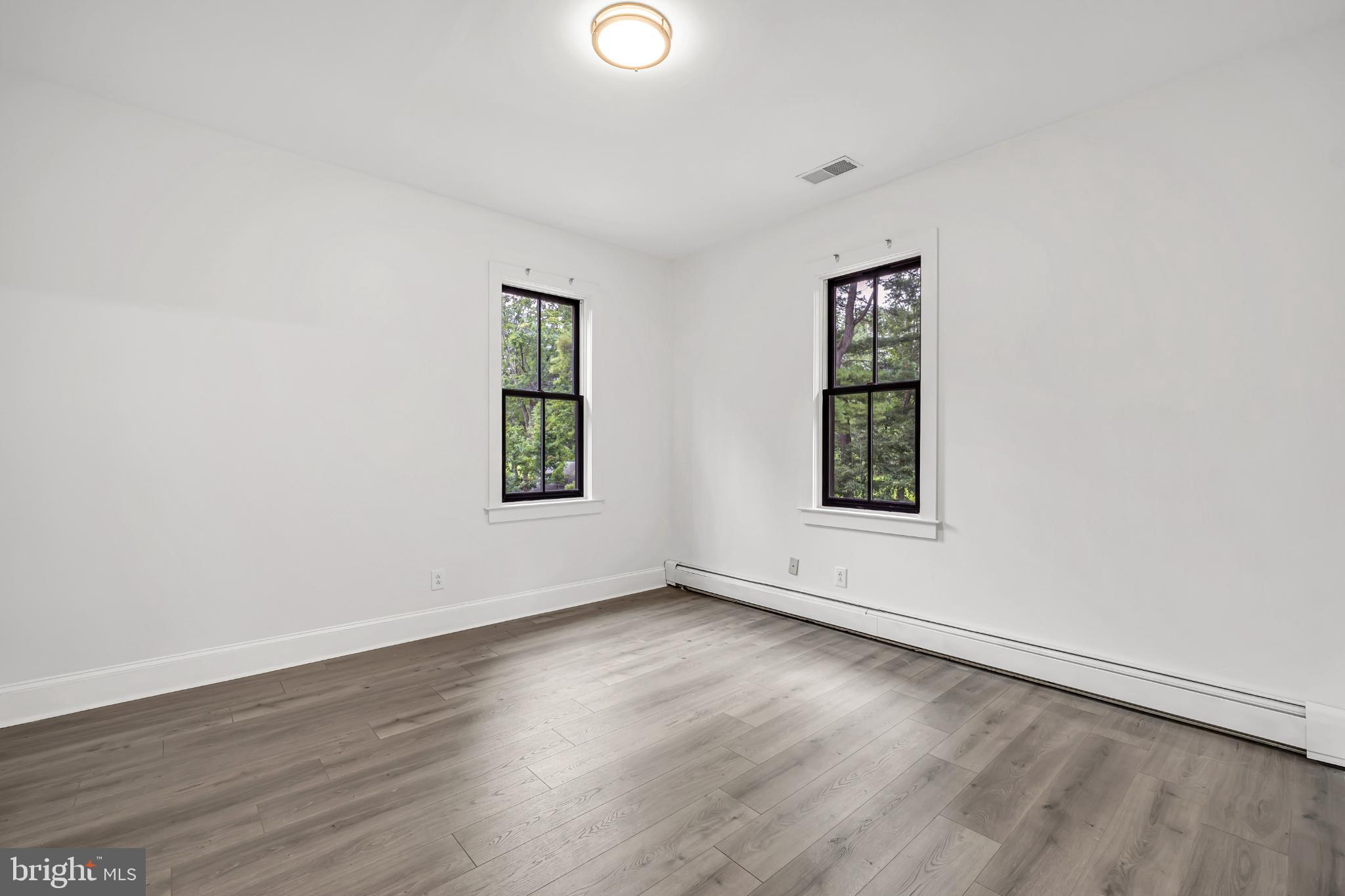 933 Fox Chase Road Jenkintown, PA 19046 - Photo 29 of 39 an empty room with wooden floor and windows
