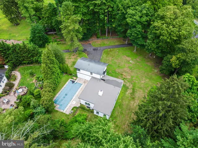 an aerial view of a house with pool yard and outdoor seating