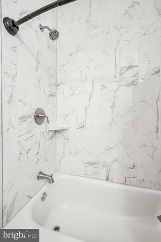 a bathroom with a bathtub and shower