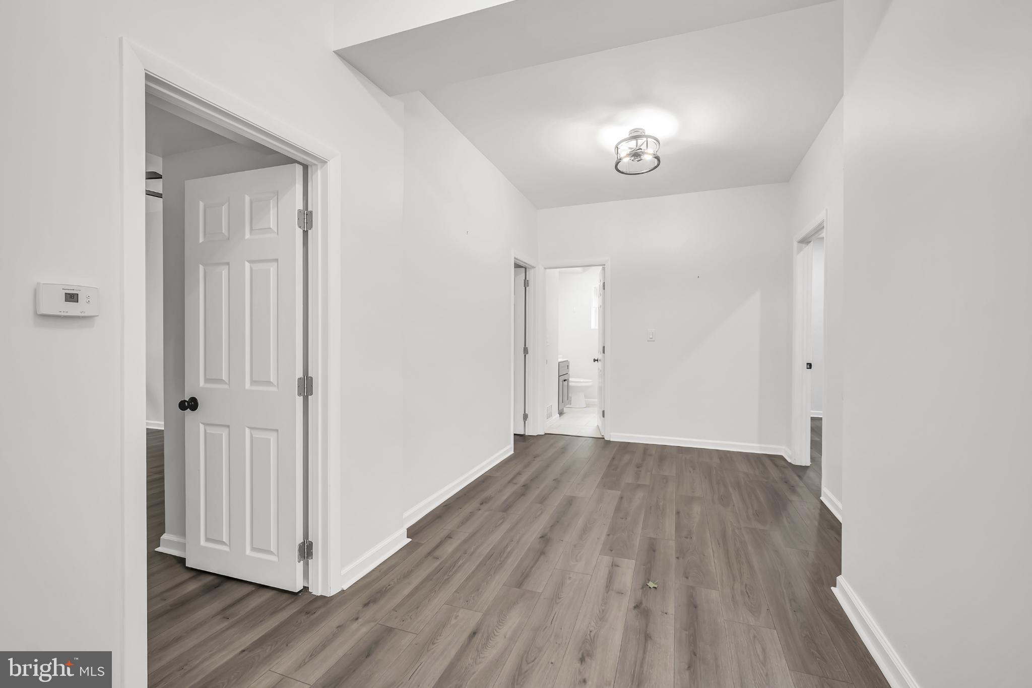 933 Fox Chase Road Jenkintown, PA 19046 - Photo 33 of 39 an empty room with wooden floor and mirror