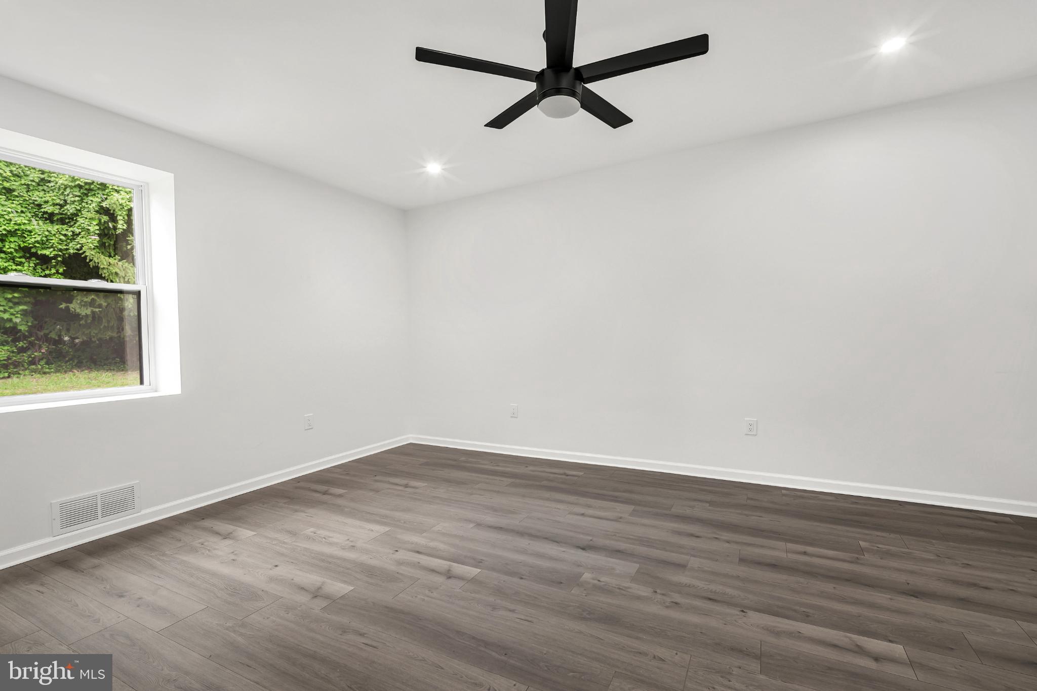 933 Fox Chase Road Jenkintown, PA 19046 - Photo 35 of 39 an empty room with wooden floor and windows