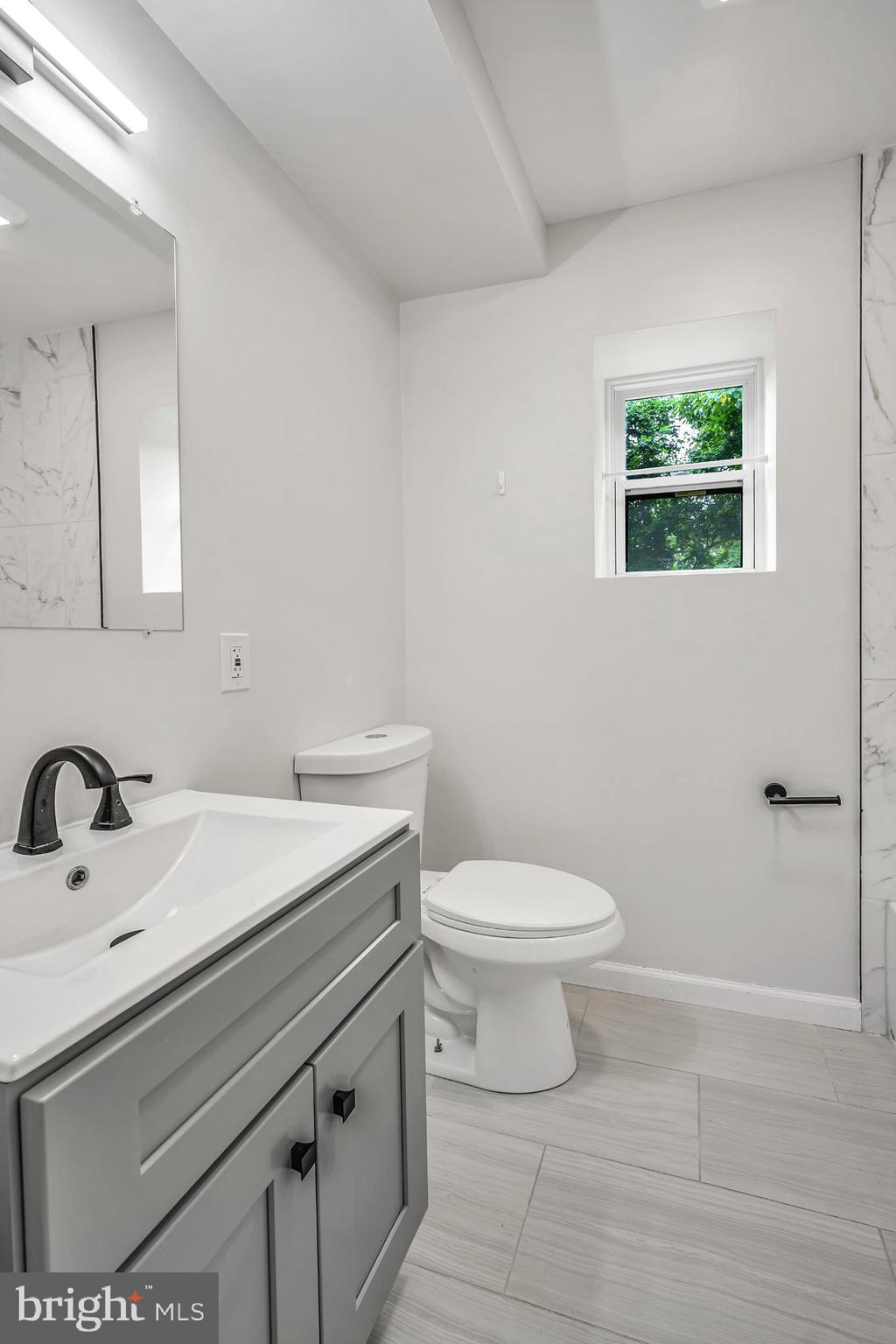 933 Fox Chase Road Jenkintown, PA 19046 - Photo 37 of 39 a bathroom with a sink a toilet and mirror