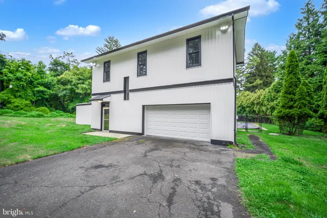 a front view of house with yard and trees