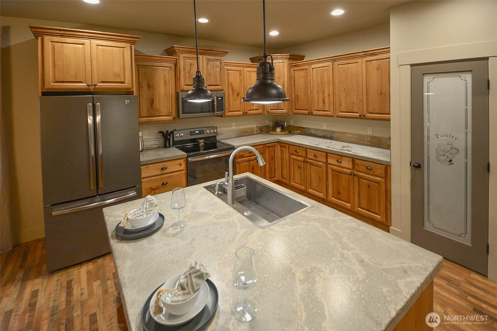 259 Parkside Loop Chehalis, WA 98532 - Photo 11 of 39 a kitchen with stainless steel appliances granite countertop a refrigerator a stove and a sink with wooden floor
