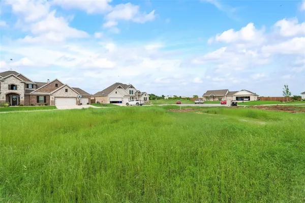 a view of a house with a big yard and garden