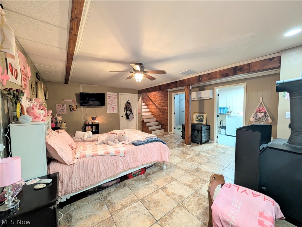 6700 McCaslin Road Nashport, OH 43830 - Photo 29 of 30 Interior room featuring textured wall finishes, a ceiling fan, and exposed wood beams