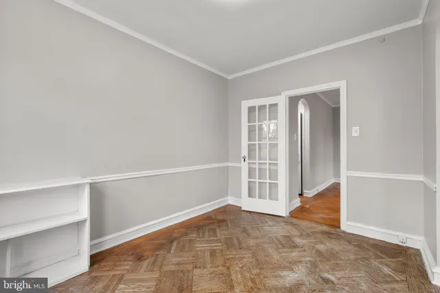 a kitchen with a stove cabinets and a window