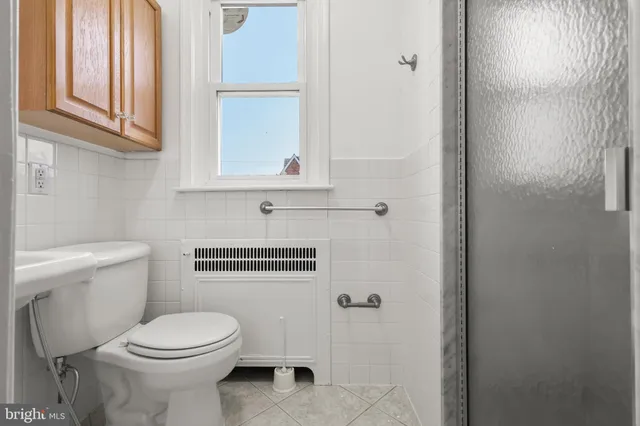 a bathroom with a glass shower door