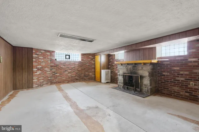 a white toilet sitting next to a white sink and vanity