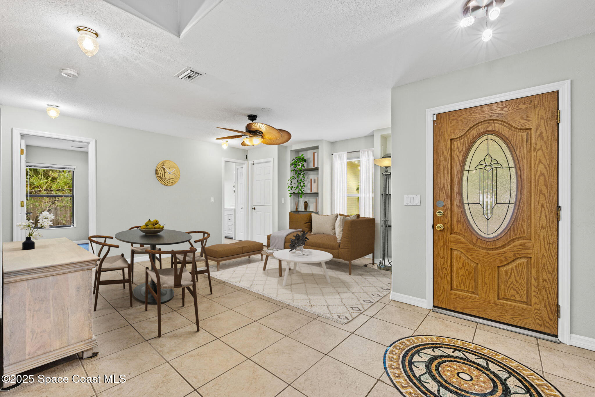 2568 Longwood Boulevard Melbourne, FL 32934 - Photo 11 of 42 a living room with furniture a window and stainless steel appliances