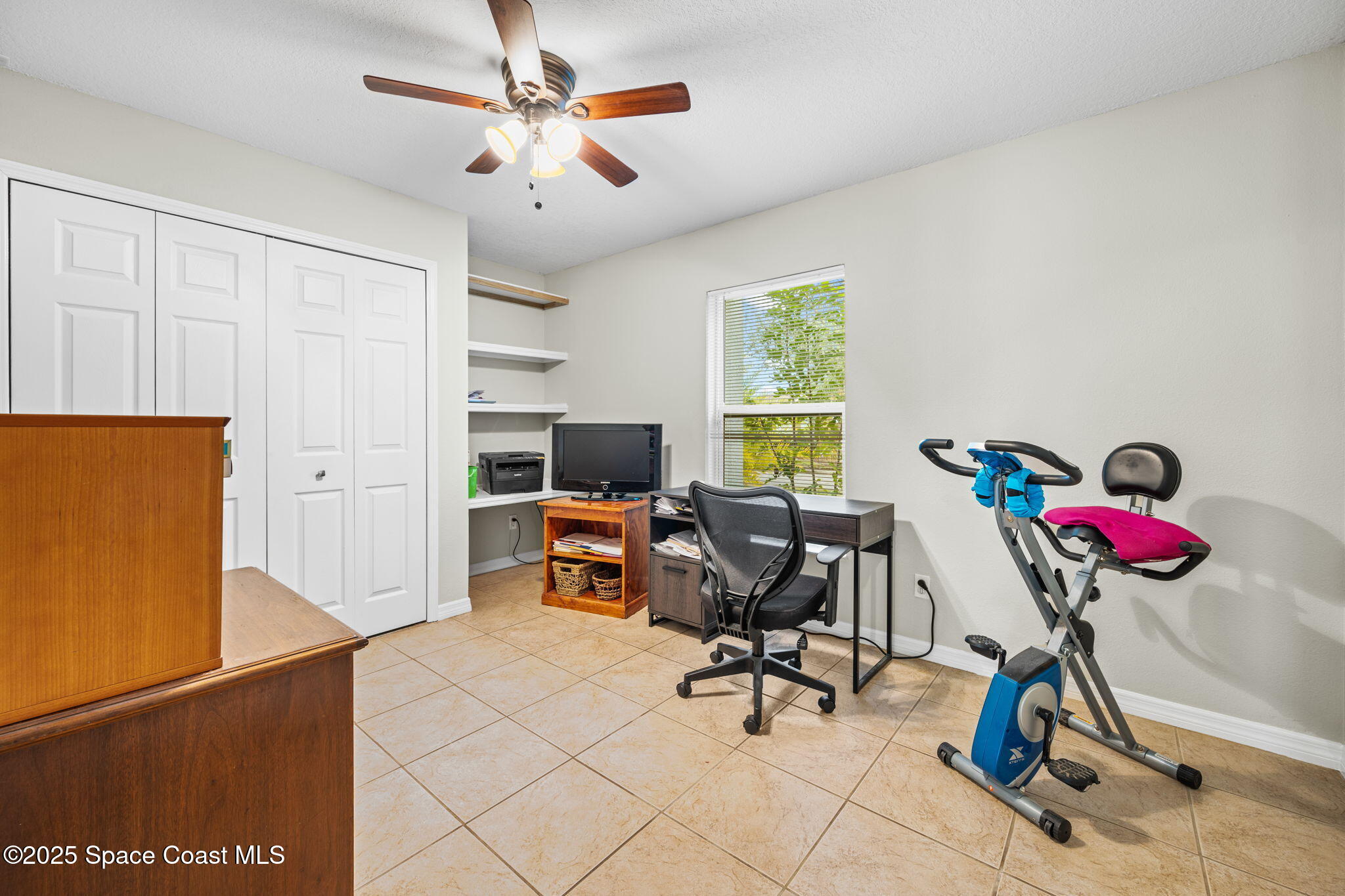 2568 Longwood Boulevard Melbourne, FL 32934 - Photo 14 of 42 a view of a workspace with furniture and a window