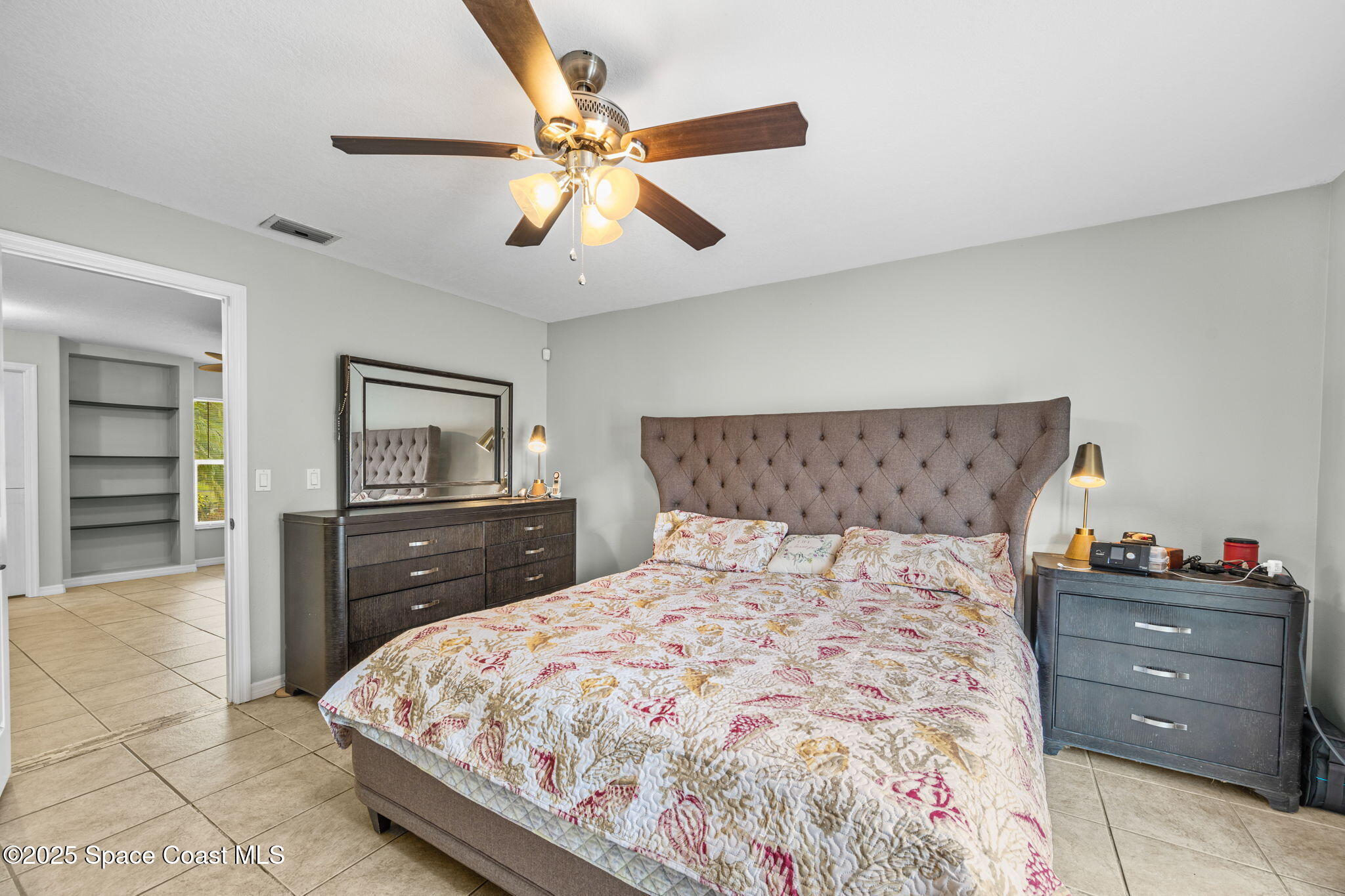 2568 Longwood Boulevard Melbourne, FL 32934 - Photo 18 of 42 a bedroom with a bed and a dresser